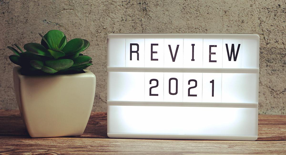 Review 2021 word in light box on wooden background