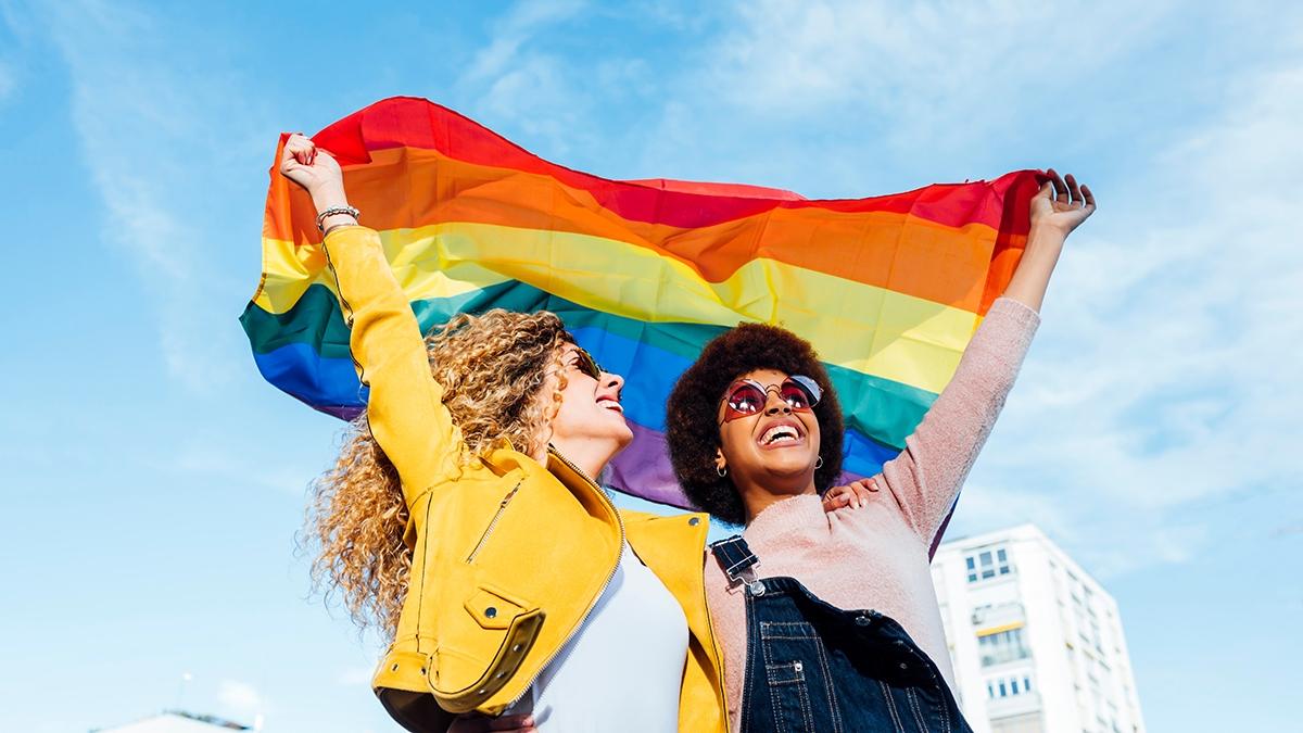 pride month gifts two women holding pride flag