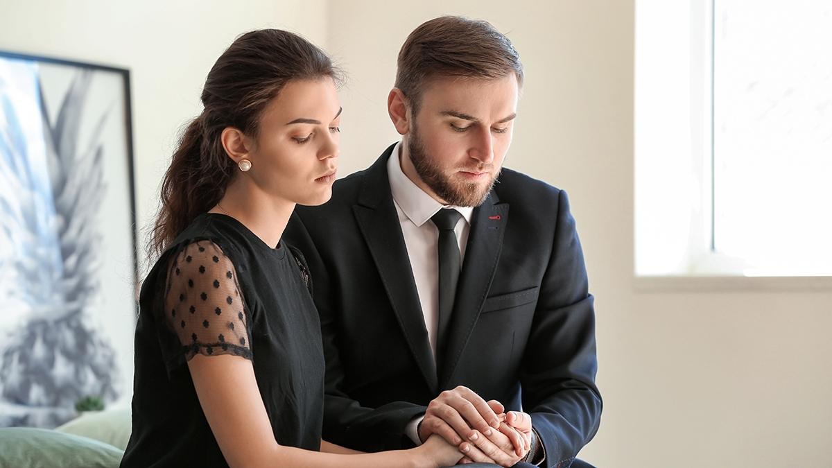 Couple mourning at funeral