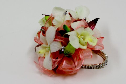 white orchid prom corsage with coral ribbons