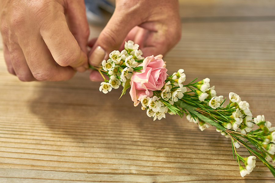 Continue adding wax flowers