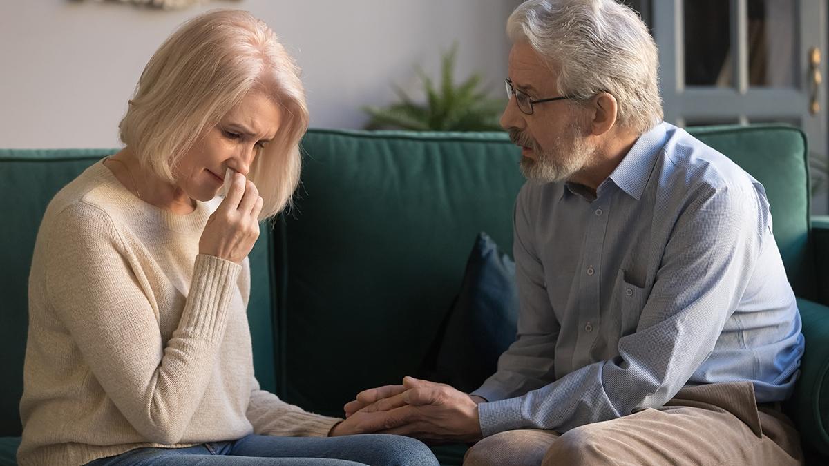 Loving kind old husband consoling comforting sad crying grieving middle aged wife, senior spouse talking give empathy compassion help with health problem in trust retired couple marriage relationship