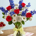 red, white and blue flowers with yellow ribbon