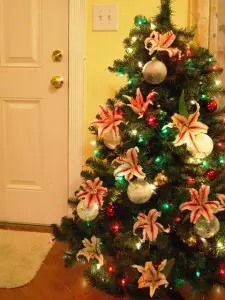 A Christmas Tree Decorated With Fresh Flowers