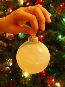 A Glass Ornament Sprayed With Canned Snow