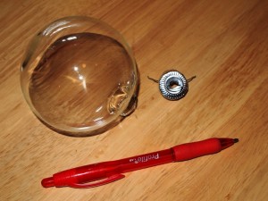 How to Use a Pen to Punch a Hole Through an Ornament Cap