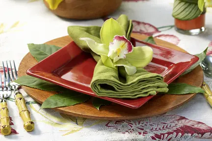 a photo of how to host a luau party with orchid place settings