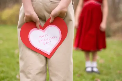 Boy Hiding Valentine's Day Card From Girl