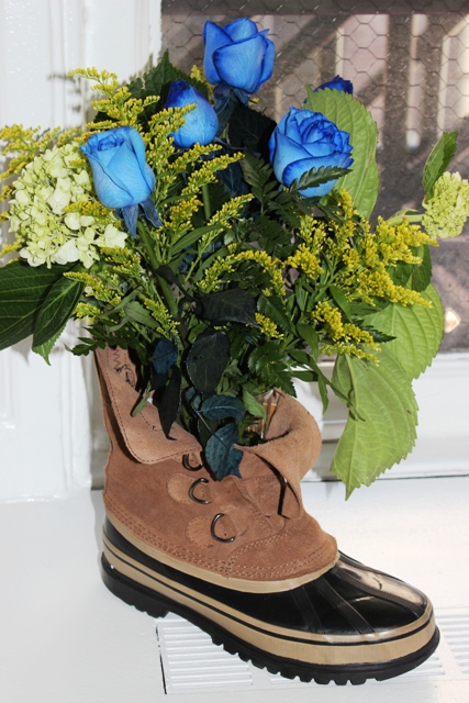 A photo of fathers day diy gifts with Flowers and Vase Placed in a Construction Boot