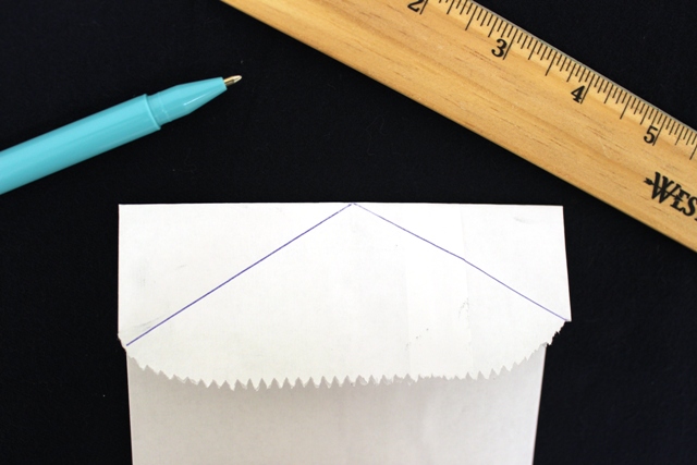 A photo of diy gift bags with Traced Lines on a Paper Bag to Create a Collared Shirt
