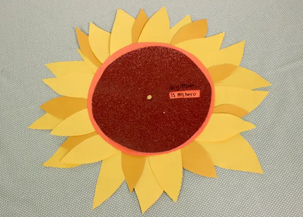 a photo of a sunflower wheel of appreciation: mom is my hero message