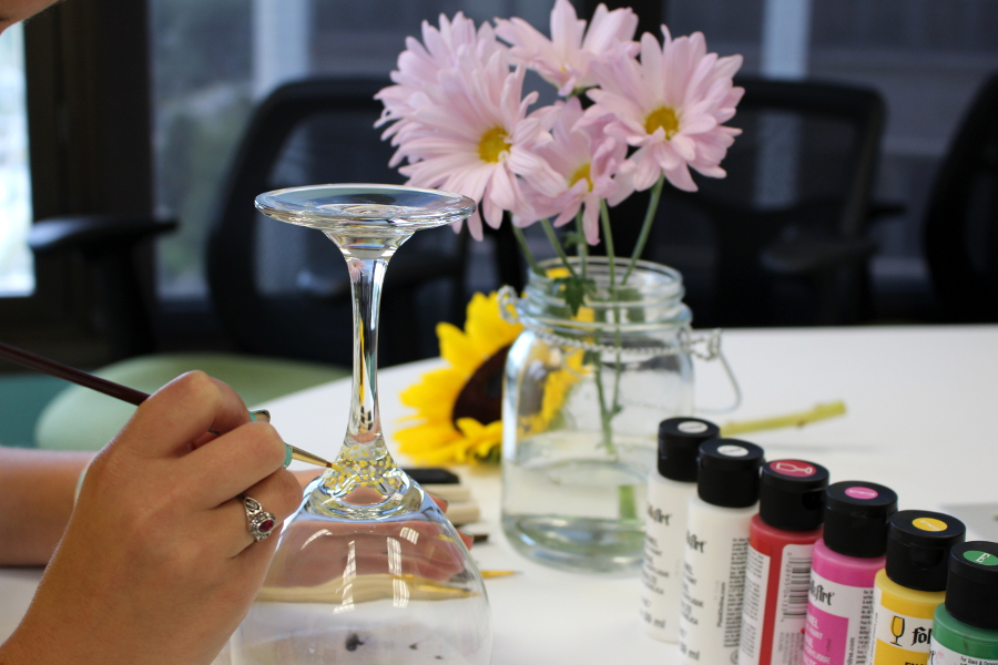 hand painted wine glasses with Painting the center of the flower using a small brush and creating dots