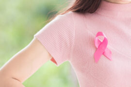 Close up Happy woman with a pink ribbon for Prevention Breast