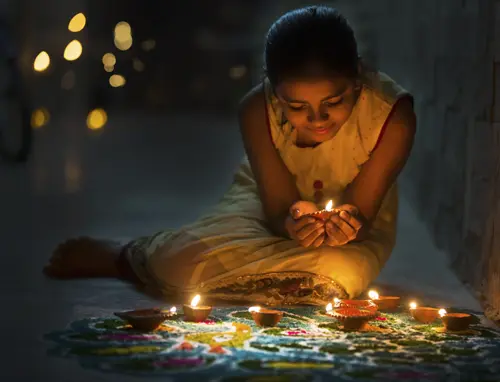 diwali with girl holding a candle on Diwali