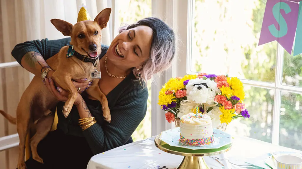 dog birthday party owner holding dog