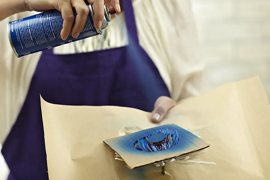 painted flowers with Spray the blue paint onto flower