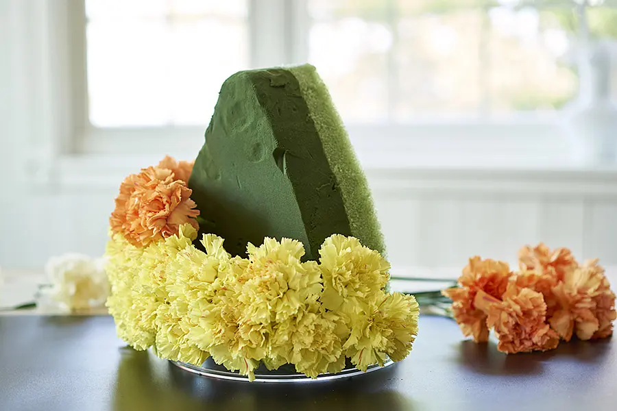 candy corn decorations with 2 Rows of Yellow Carnations