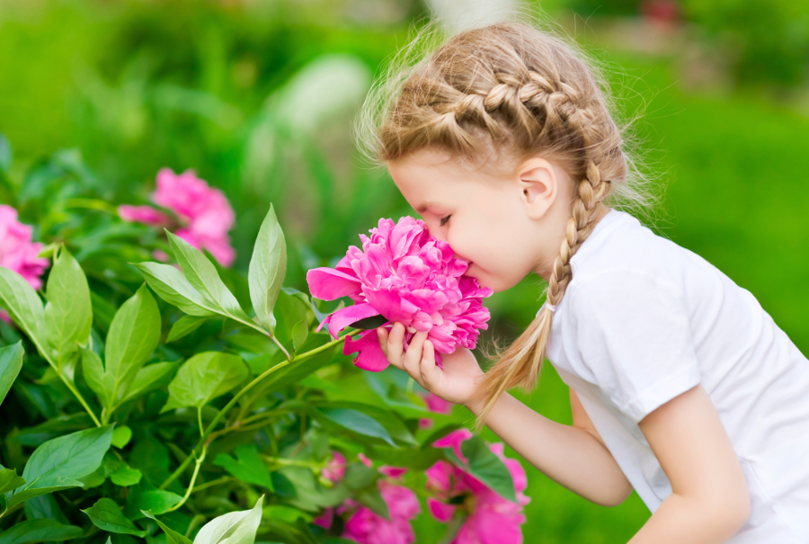 Girl Smelling Pink Flower