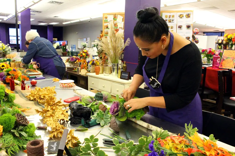 Alejandra arranging greens on her birch branch centerpiece