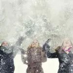 winter with girls throwing snow in the air