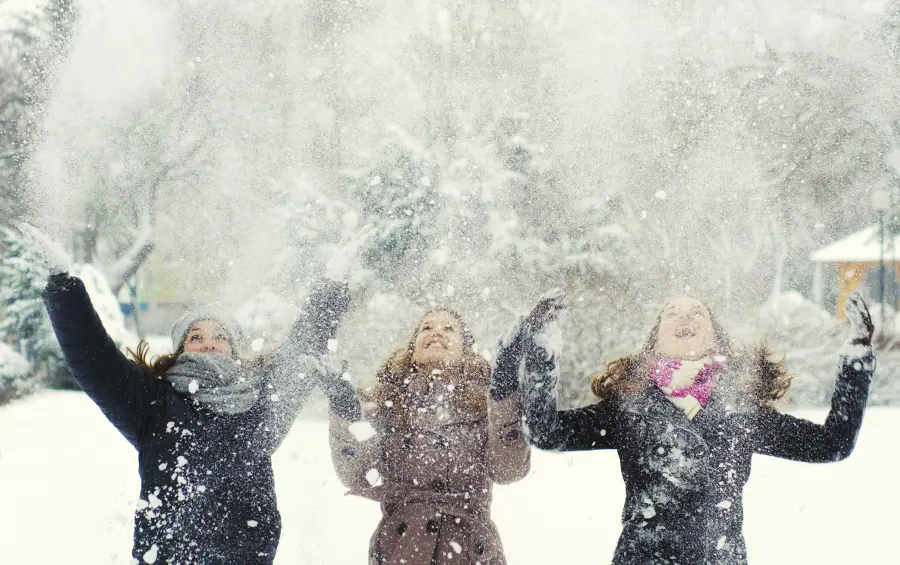 winter with  Girls throwing snow in the air