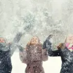 Three teenage girls having fun in the winter snow