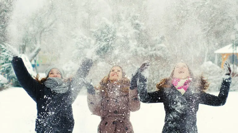 Three teenage girls having fun in the winter snow