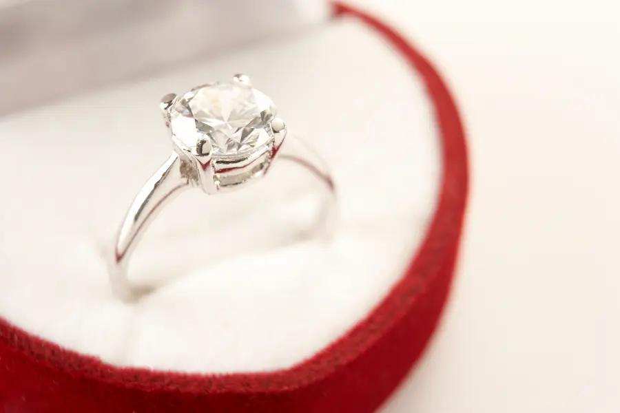 Valentine's Day proposal engagement ring in a white and red box.
