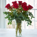 Red roses arranged in a vase.