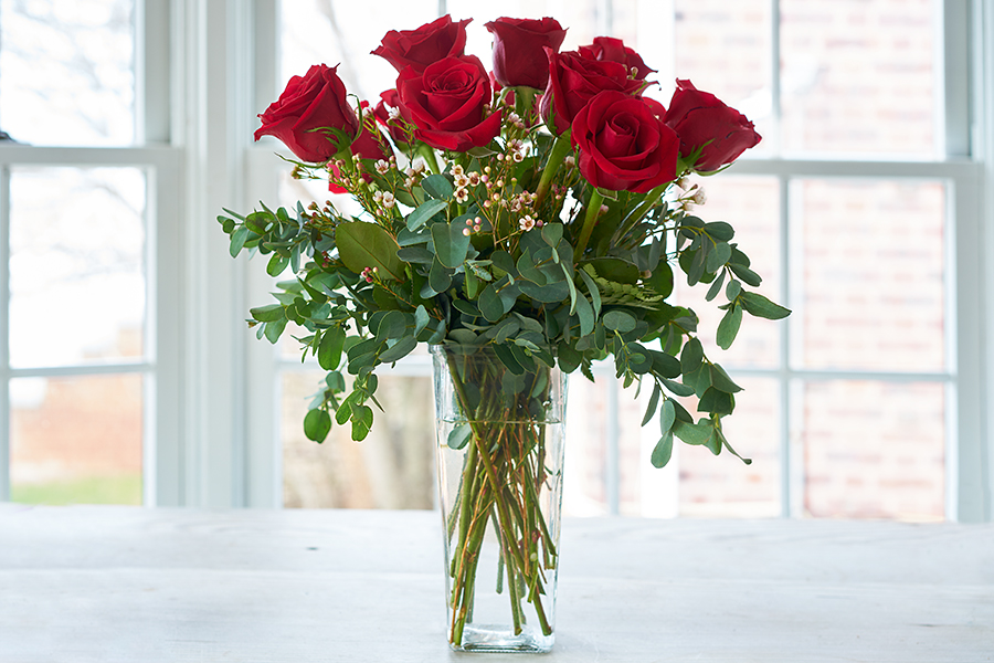 Red roses arranged in a vase.