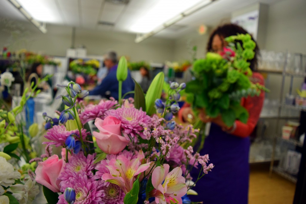Flowers with florists arranging in the background
