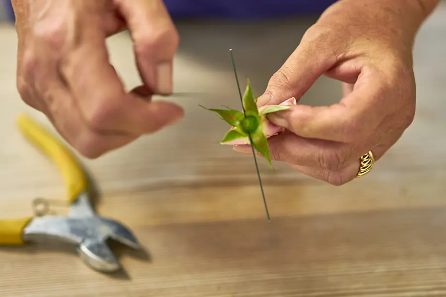 Put wire through rose stem