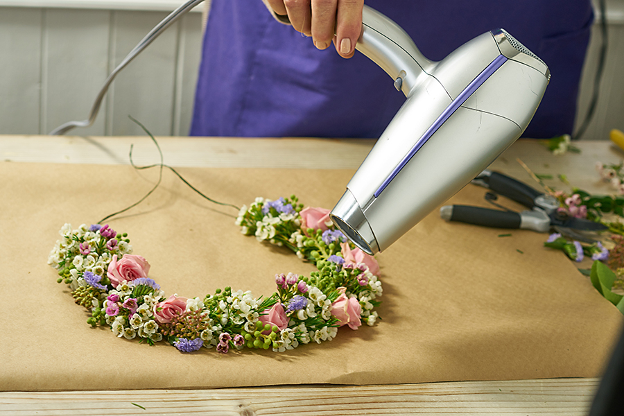 Use a hairdryer to get rid of hot glue strings