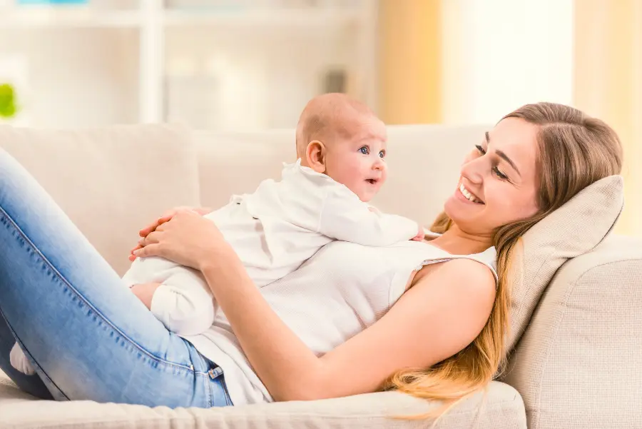 Portrait of happy mother and baby at home
