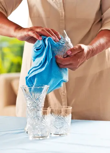 how to clean glass vases with woman cleaning glassware