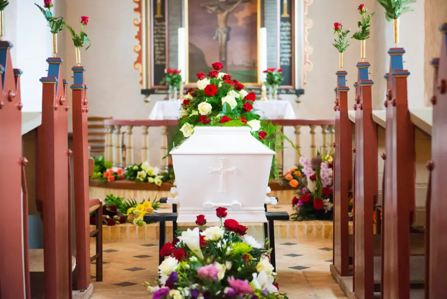 history of funeral flowers with flowers on a casket