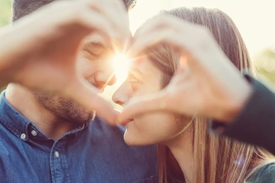 Couple making a heart with their hands