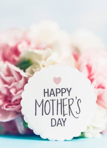 A photo of official mothers day flower with a bouquet of flowers and text that says "happy mother's day".