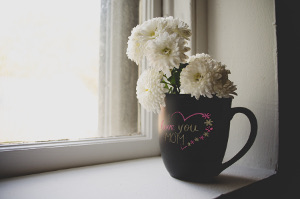a photo of mother's day flower decorations: flowers in a mug