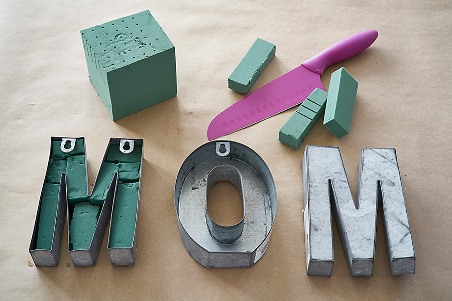 a photo of a mom floral centerpiece: metal letters and floral foam