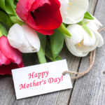 Tulips with tag and text for mother's day on wooden background