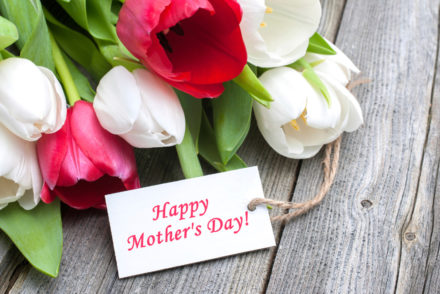 Tulips with tag and text for mother's day on wooden background
