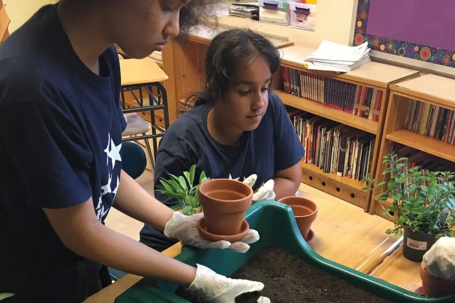 Kids Putting Soil in Pots