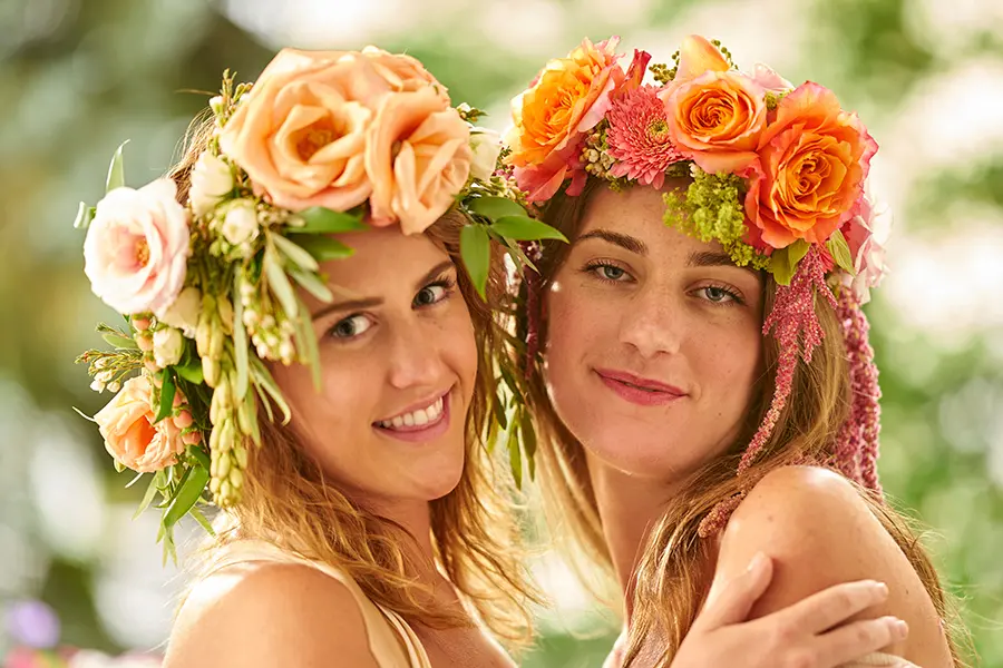 Two Young Women Wearing Flower Crowns