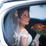 Bride with bouquet in car