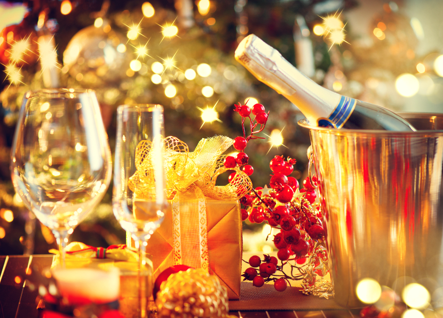 champagne bottle and glasses on table holiday guide