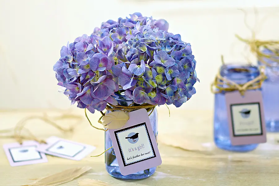 baby shower decor ideas with purple hydrangea in a purple mason jar