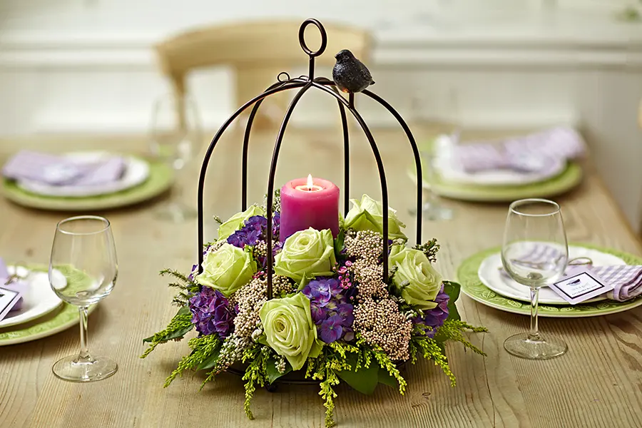 baby shower decor ideas with Bird cage centerpiece with flowers and candle