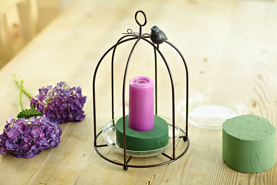 baby shower decor ideas with Bird cage centerpiece with purple candle placed on foam piece
