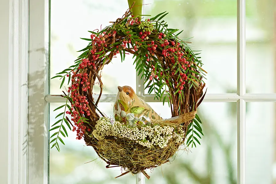 baby shower decor ideas with Grapevine wreath with fresh pepper berry, rice flower, and a faux bird